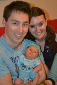 happy adoptive parents show off their newly adopted baby