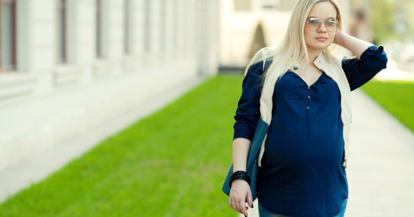 Blonde pregnant woman walking outdoors