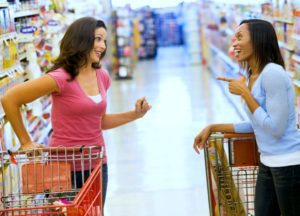Hopeful adoptive mother talking with a friend at a grocery store