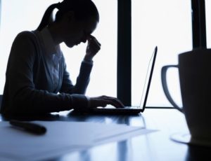 Woman office worker in silhouette, stressing out
