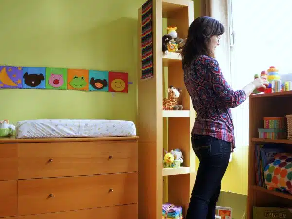 An adoptive mother assembling her future baby's nursery