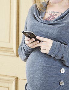 pregnant woman texting about adoption plan