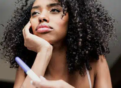 sad woman holding pregnancy test