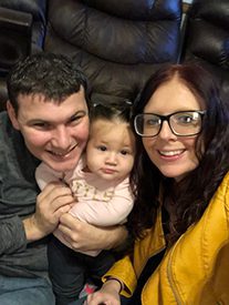 happy adoptive parents show off their adopted baby
