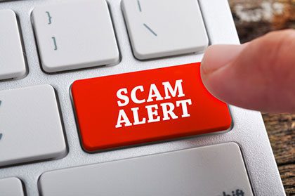 Scam alert button on a computer keyboard, Lifetime Adoption experts are good at spotting and avoiding scams