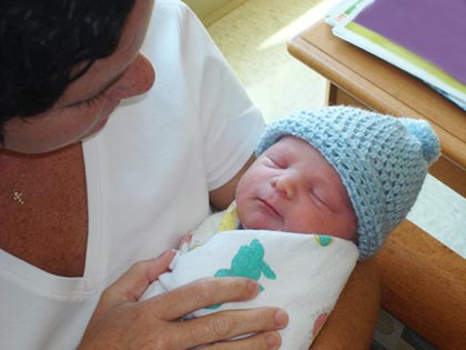 single parent holds her new baby in her arms after her adoption