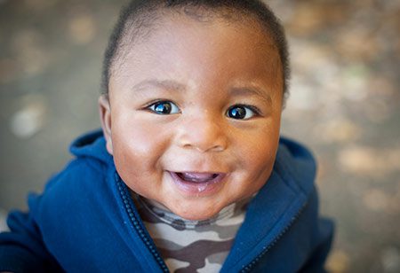 Smiling African American adopted infant