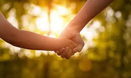 parent and child hold hands