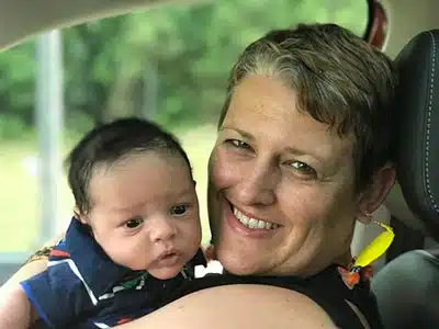 Newly adoptive Caucasian mother lovingly holding her adopted Biracial infant