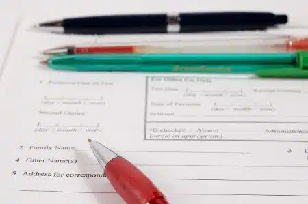 birth certificate and pens ready to sign