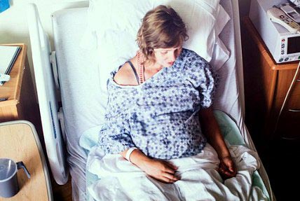 Pregnant woman looks at adoptive families on her phone
