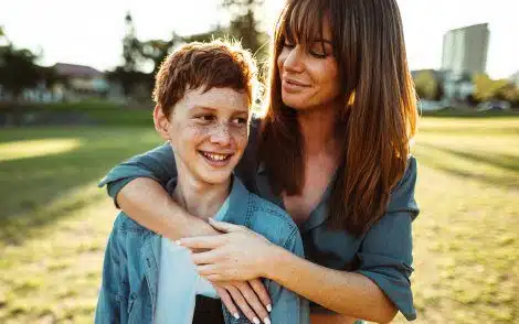 Birth mother visits with her son in a park