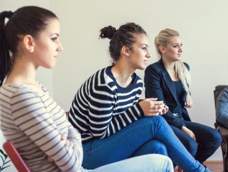 Three young women at a birth mother support group meeting