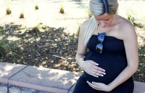 Pregnant woman sitting at a park