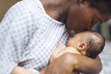 Birth mother holds her baby at the hospital