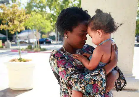birth mother in an open adoption visit with her daughter