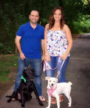 Justino and Gina pose with their dogs for their adoption profile