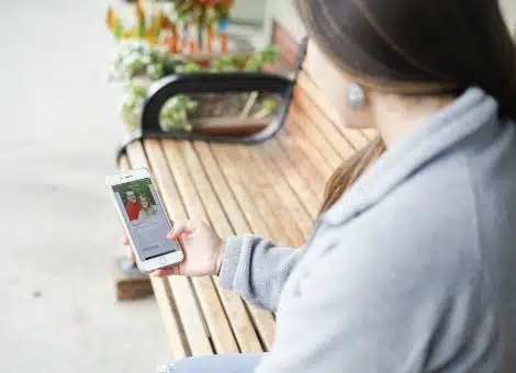 Woman looks at adoptive parent profile on her phone