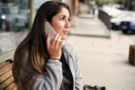 Woman talking on a cell phone, thinking of questions to ask adoptive parents