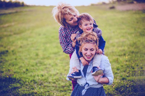 Adoptive mom, child, and birth mother enjoying an open adoption visit