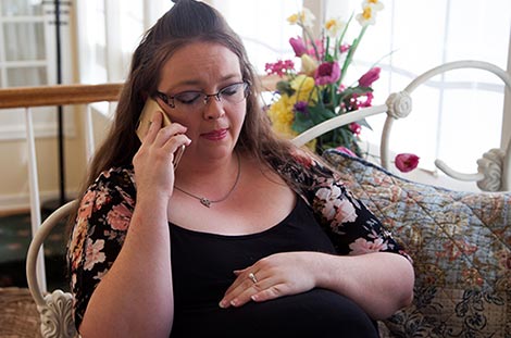 Pregnant woman talks to a peer support counselor about adoption