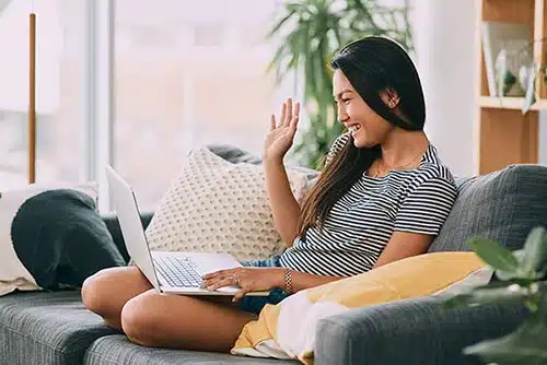 Birth mother waves to the adoptive family and her child during a Skype call