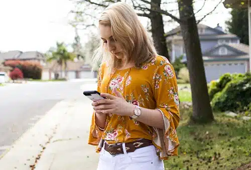 Woman texting with a birth mother from Lifetime's Peer Support Network