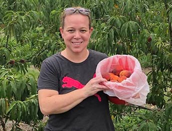 Kathryn with the peaches collected from a peach farm
