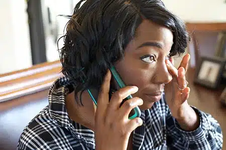 Birth mother grieving her loss talks on the phone to a counselor