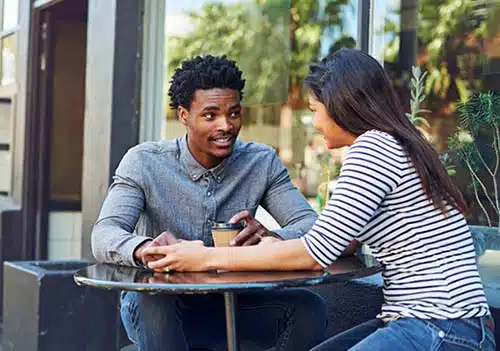 Couple enjoying coffee as husband follows tips on how to support your wife during the adoption wait