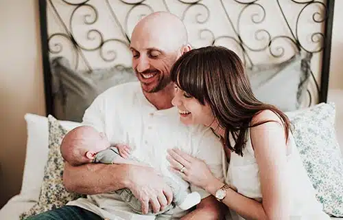 National Adoption Month is celebrated every November by adoptive families like this one, admiring their infant son