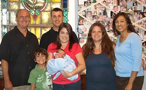 Veronica with the adoptive family, birth mother, and adoption attorney