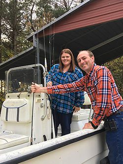 Hopeful adoptive parents Bryan and Michele pose by their boat