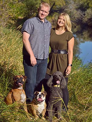 Hopeful adoptive parents Cody and Ashley pause during a walk with their three dogs