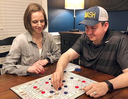 Hopeful adoptive parents Allison and Jonathan playing a board game called Sequence
