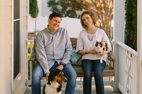 Waiting adoptive couple Jonathan and Allison relaxing their their dog and cat on the front porch