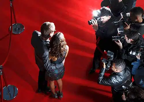 Two celebrities who were adopted pose on the red carpet