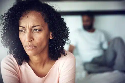 Infertile, unhappy African American couple in their bedroom