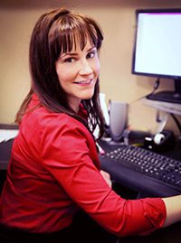 Lifetime Adoption Content Creator and Video Coordinator Heidi Keefer working at her desk