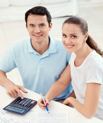 young couple look online for ways to fund their adoption, through loans, grants