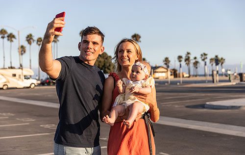 Young couple take a selfie with daughter whom they adopted after following California adoption laws