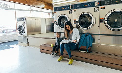 Student parent studying at laundromat