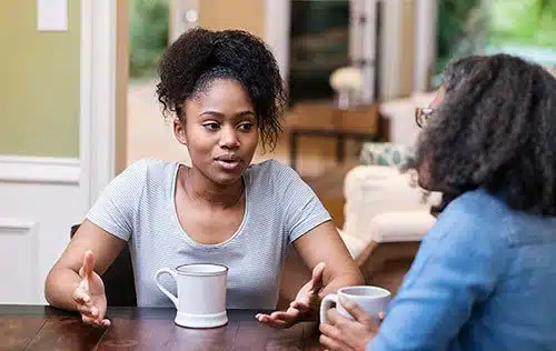 Young woman discusses adoption with her mom