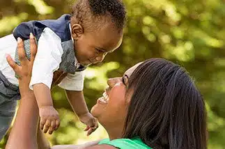 African American woman holding her adopted child in Jacksonville