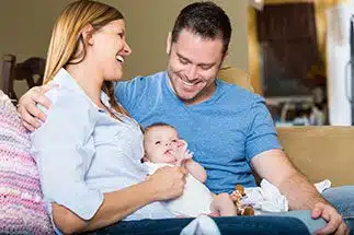 An adoptive family holding their newly adopted baby