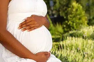 Birth mom in Jacksonville holding her pregnant belly