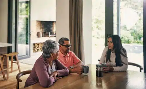 Hopeful adoptive mom talks to her parents about modern adoption in their kitchen