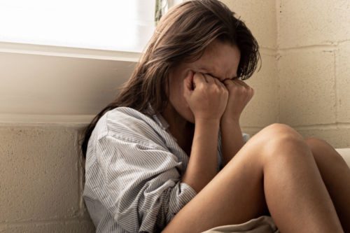 Depressed young woman in drug rehab