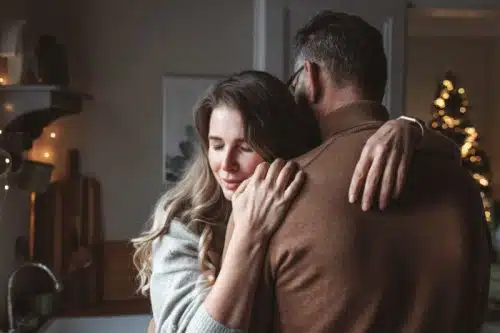 Waiting adoptive couple embracing each other during the holidays