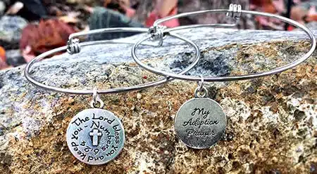 The bangle bracelet style showing what the charm reads